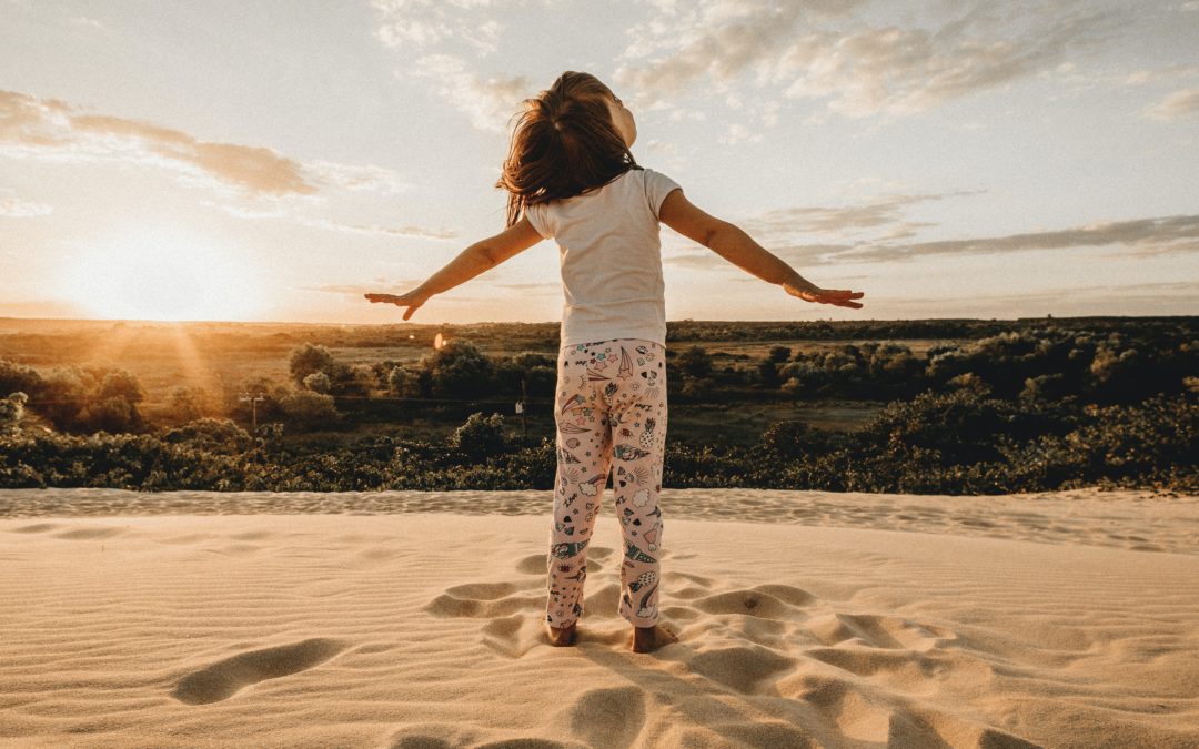 Happy child playing on the beach